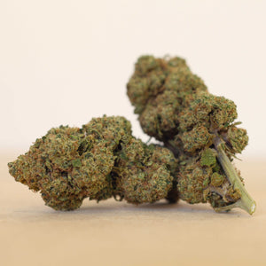 Close-up of candy kush buds on a beige background