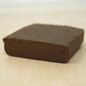 Close-up of premium OG Brown CBD hash from Little Collins