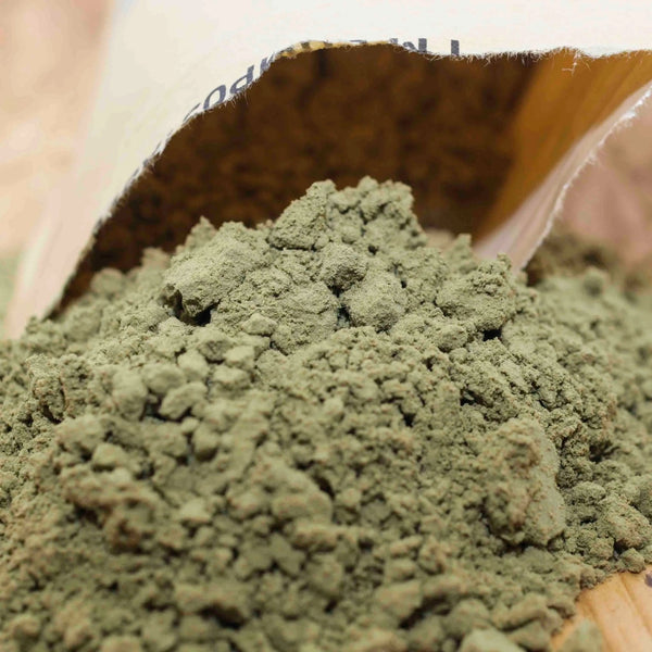 Open bag of Little Collins Hemp Protein Powder with organic hemp protein spilling onto a wooden surface.