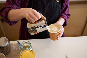 Milk being poured in to a cup of CBD Coffee