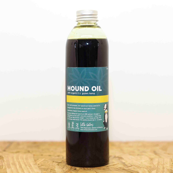 Bottle of Hemp 'Hound Oil', CBD Oil for pets, dogs & cats, on a wooden surface with a white background